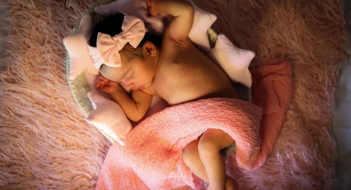 Baby sleeping on bed photoshoot